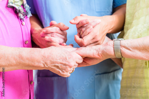 Elderly care nurse with two senior women