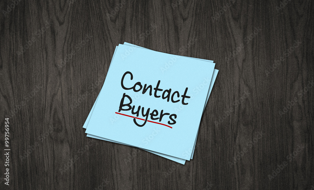 Contact Buyers written on note pad black wood background Contact Buyers written on note pad black wood background