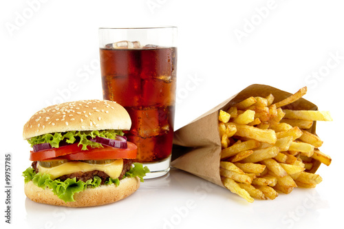 Big cheeseburger with glass of cola and french fries isolated on