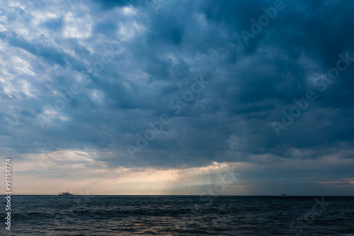 Stormy sky over ship in the sea