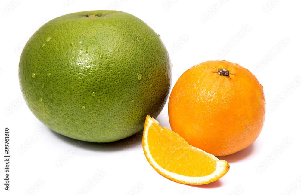 Green sweet grapefruit and orange with a cut piece isolated on white Green sweet grapefruit and orange with a cut piece isolated on white