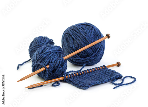 Balls of wool blue colors and knitting on wooden needles