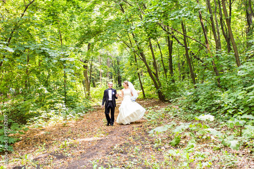 Bride and Groom at wedding Day walking Outdoors 