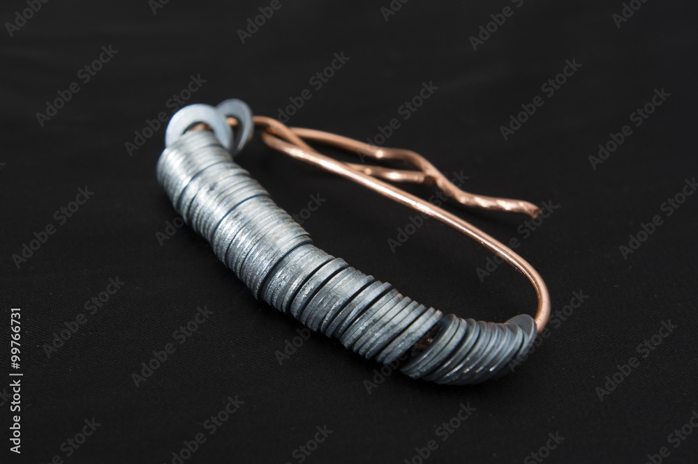 metal washers on the wire on a black background metal washers on the wire on a black background