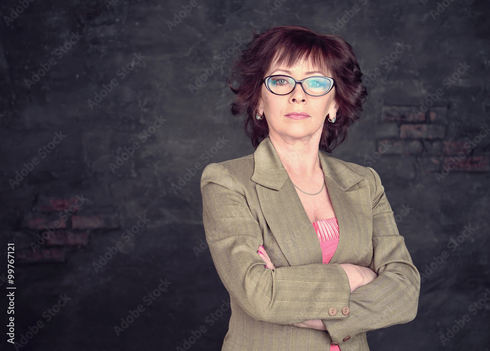 Business woman in suit on a gray background