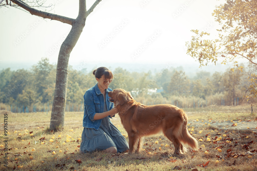 Beautiful woman with a cute golden retriever dog