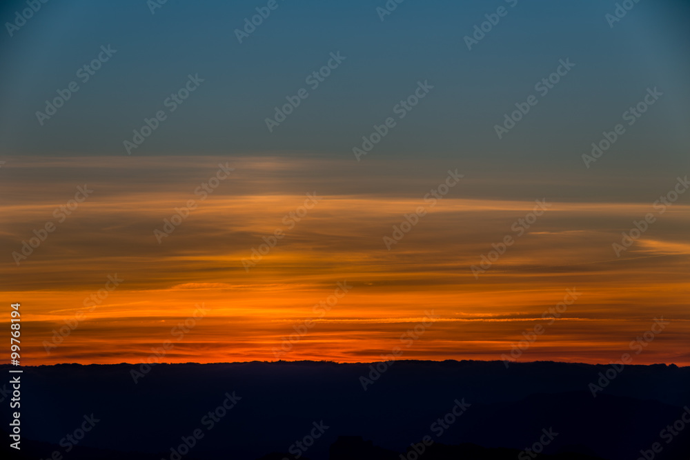 sunset on hilly countryside in winter