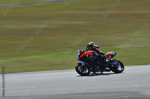 Blurred athletes practicing racing motorcycles on the race track © Thiradech