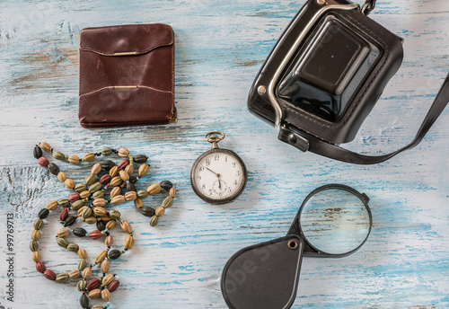 Travel concept with old camera,wallet pocket watch and magnifyin photo