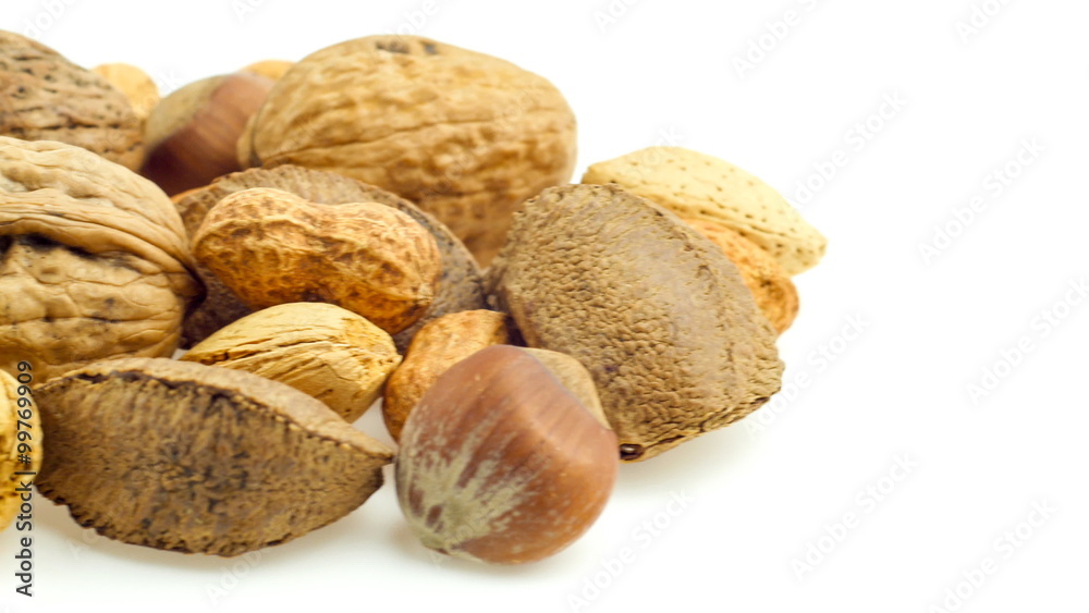 Mixed nuts isolated on white sliding in and out of frame in slow pan