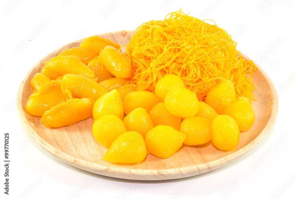 thai sweetmeat dessert made from egg and sugar on wood dish isolate on white background, top view thai sweetmeat dessert made from egg and sugar on wood dish isolate on white background, top view