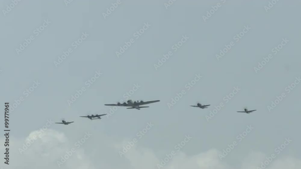 B-17 Flying Fortress leads four World War II fighter planes, approaching in formation, including a P-63 Kingcobra, a P-38 Lightning, and two P-51 Mustangs. Recorded in 4K, ultra high definition. B-17 Flying Fortress leads four World War II fighter planes, approaching in formation, including a P-63 Kingcobra, a P-38 Lightning, and two P-51 Mustangs. Recorded in 4K, ultra high definition.