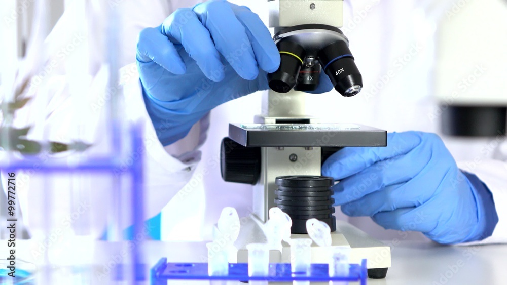 Researcher Working in Lab With Microscope.researcher in biochemical lab
