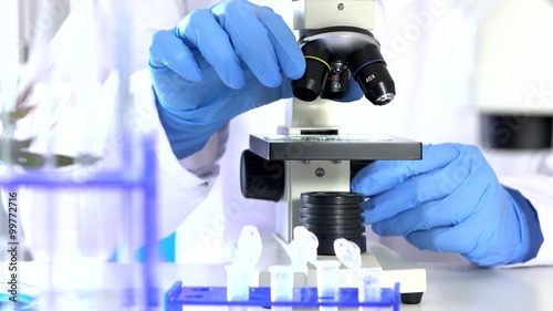 Researcher Working in Lab With Microscope.researcher in biochemical lab