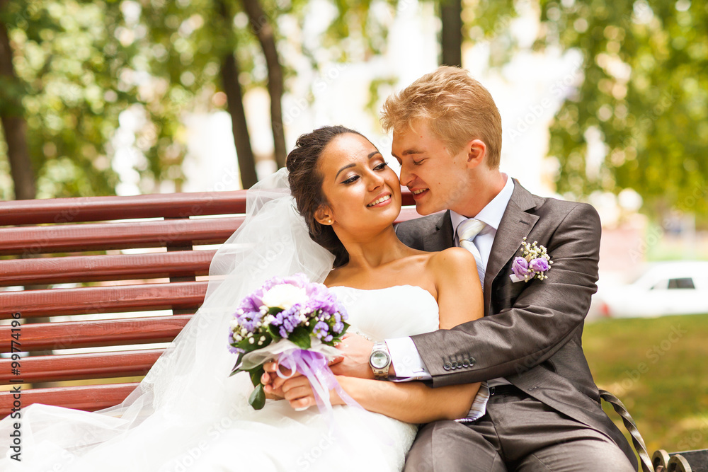 beautiful wedding couple in park. kiss and hug each other beautiful wedding couple in park. kiss and hug each other