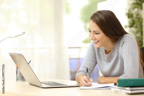 Student studying with laptop and notes