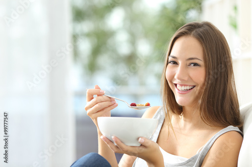 Woman eating cornflakes at home