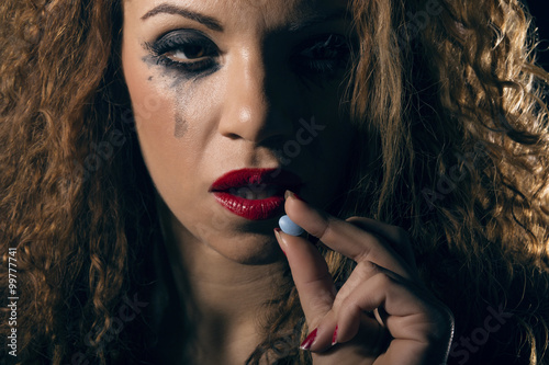 Drug abuse. Woman taking a pill. photo