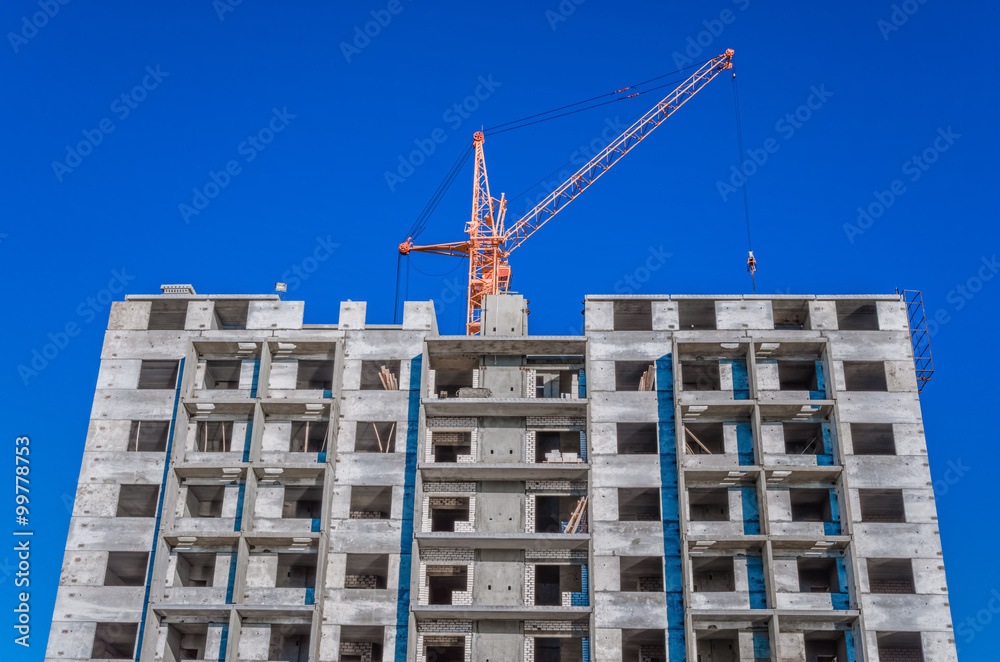 Fototapeta premium Construction of highrise houses and hoisting tower cranes