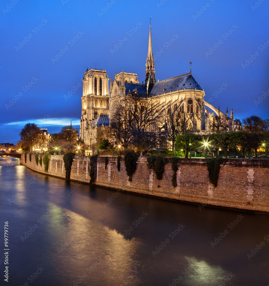 Paris, France: Notre Dame cathedral at dusk with Seine river on foreground Paris, France: Notre Dame cathedral at dusk with Seine river on foreground