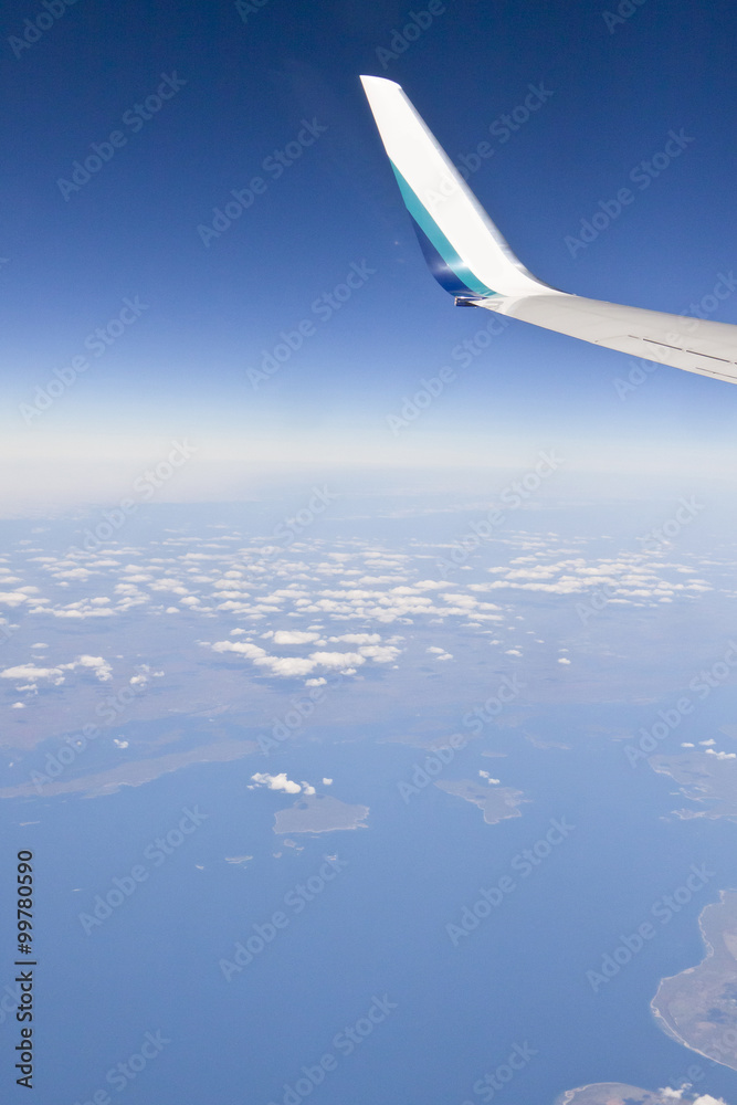aerial view over window seat of airplane flight on clear day aerial view over window seat of airplane flight on clear day