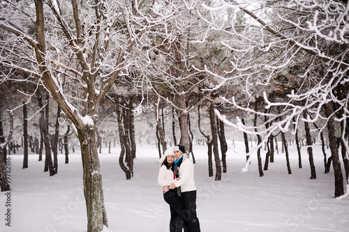 couple on the background of snowy trees
