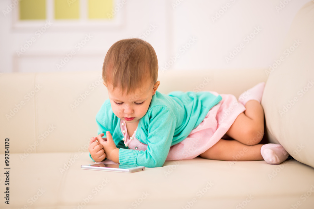 little girl plays in the smartphone. little girl plays in the smartphone.