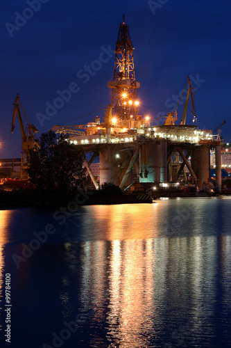 Night view of the oil rig standing during the renovation in Gdansk Repair Shipyard