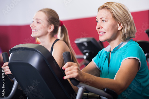 Women training on exercise bikes together