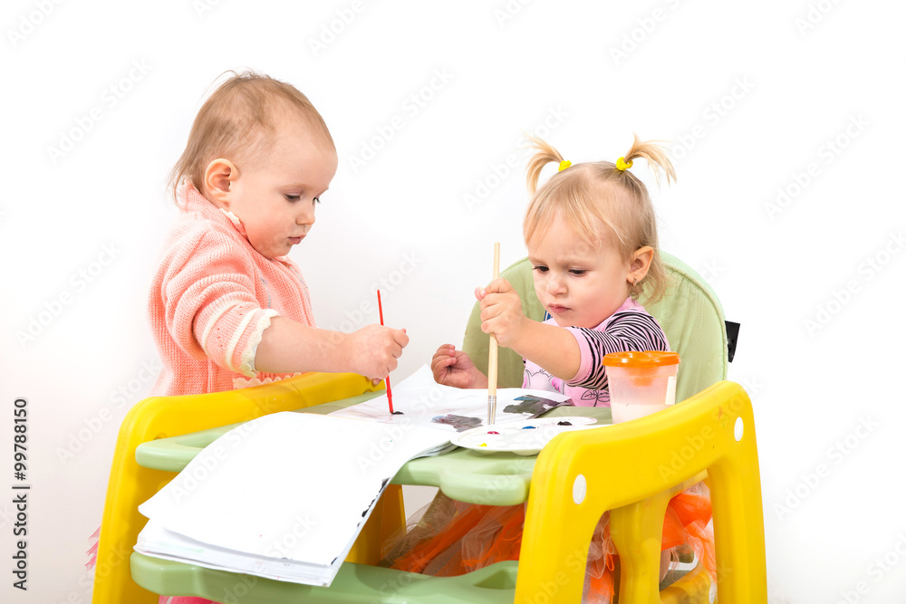 Children, little girls sitting at the table and draw Children, little girls sitting at the table and draw