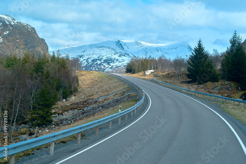 Grey asphalt road in Norvegian mountains in summer day photo