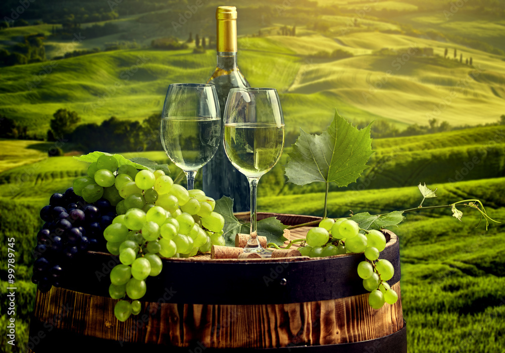  wine bottle and wine glass on wodden barrel. Beautiful Tuscany