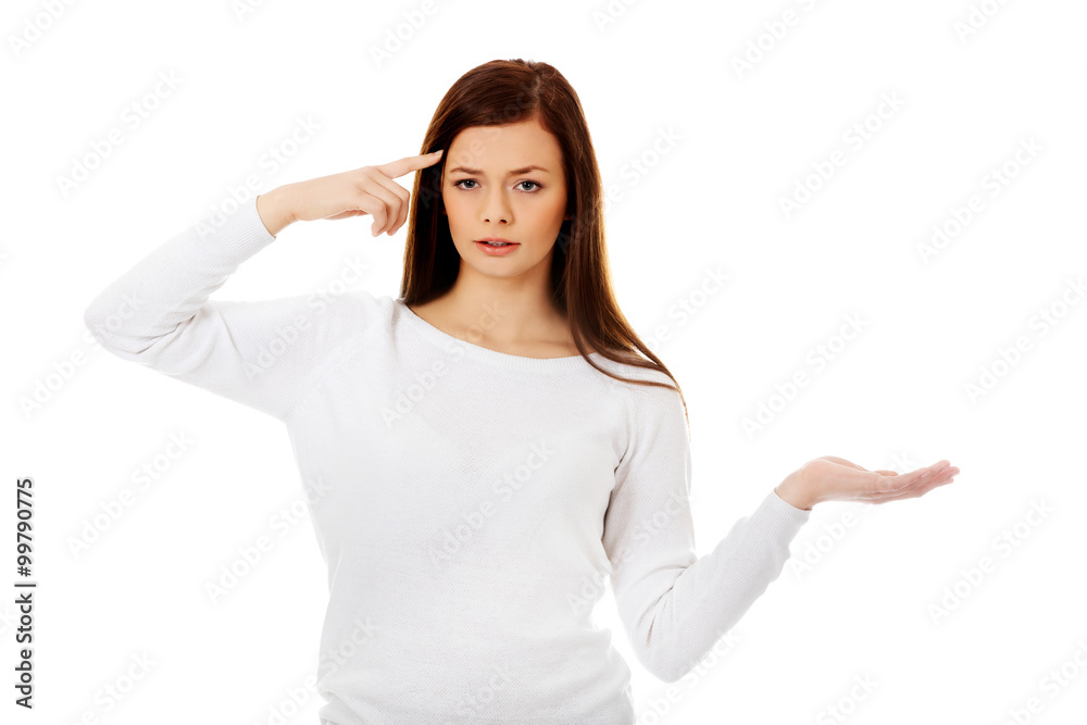 Young student woman holding something on open palm Young student woman holding something on open palm