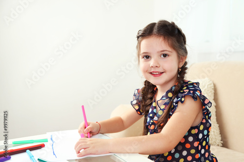 Cute little girl drawing pi...