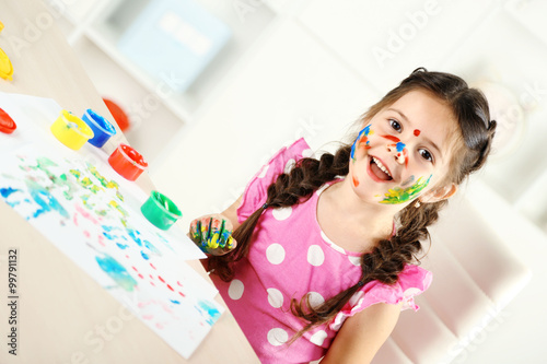 Cute little girl painting p...