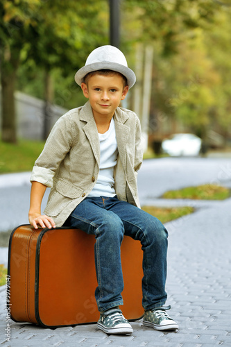 Little boy with suitcase in...