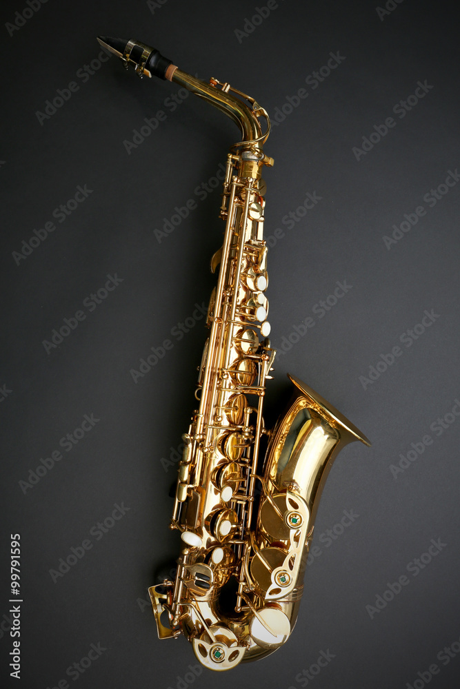 Obraz premium Beautiful golden saxophone on black background
