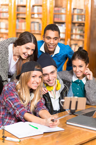 Students making selfies in library