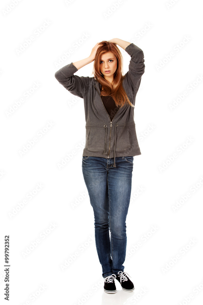 Teen woman with headache holding her hand to the head Teen woman with headache holding her hand to the head