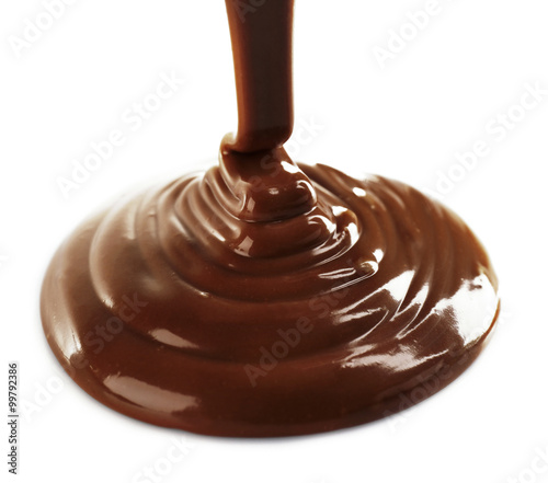 Melted milky brown chocolate pouring  isolated on white
