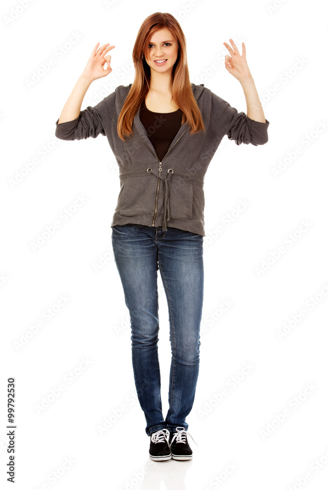 Teenage woman showing two OK signs Teenage woman showing two OK signs