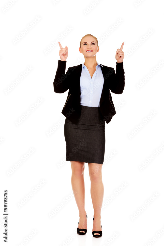 Young smiling business woman pointing up Young smiling business woman pointing up