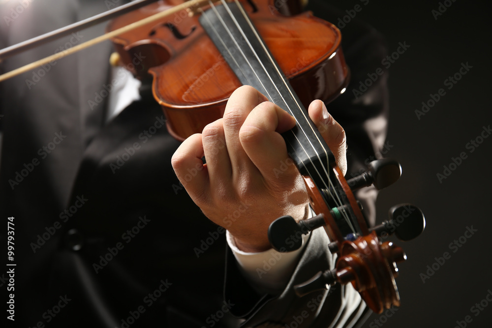 Musician play violin on black background, close up Musician play violin on black background, close up