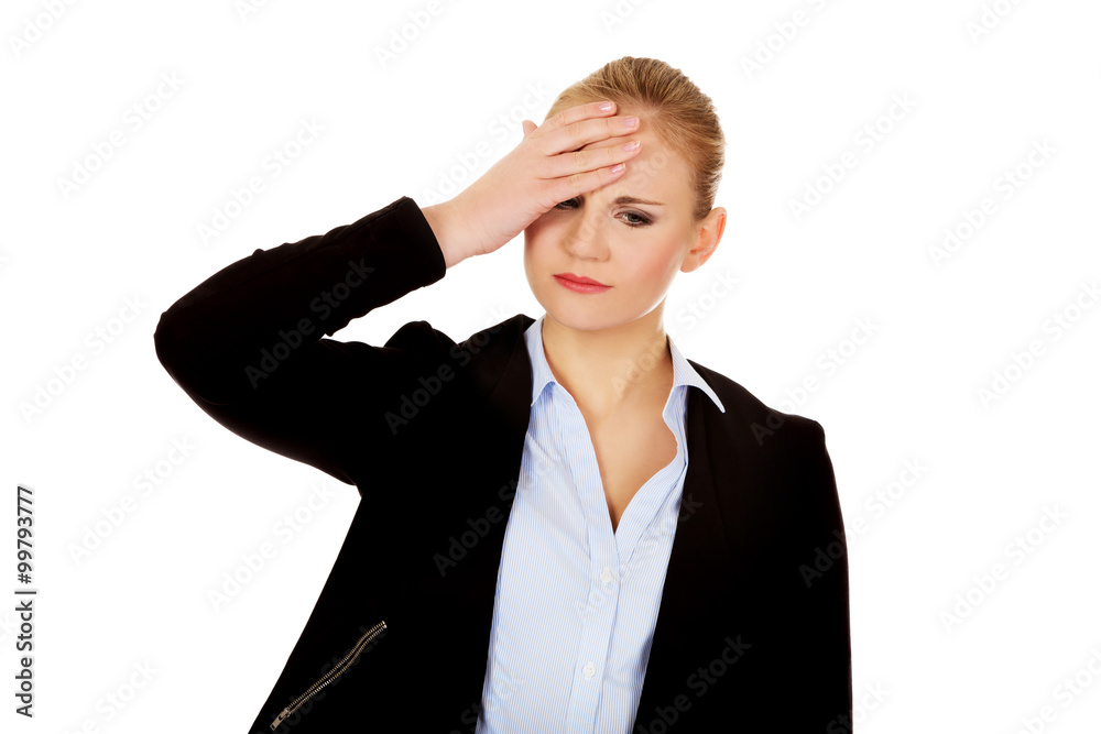 Business woman with a huge headache holding head Business woman with a huge headache holding head