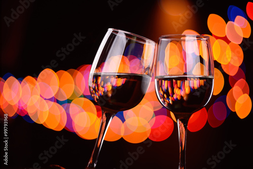 Two wine glasses clink at the party