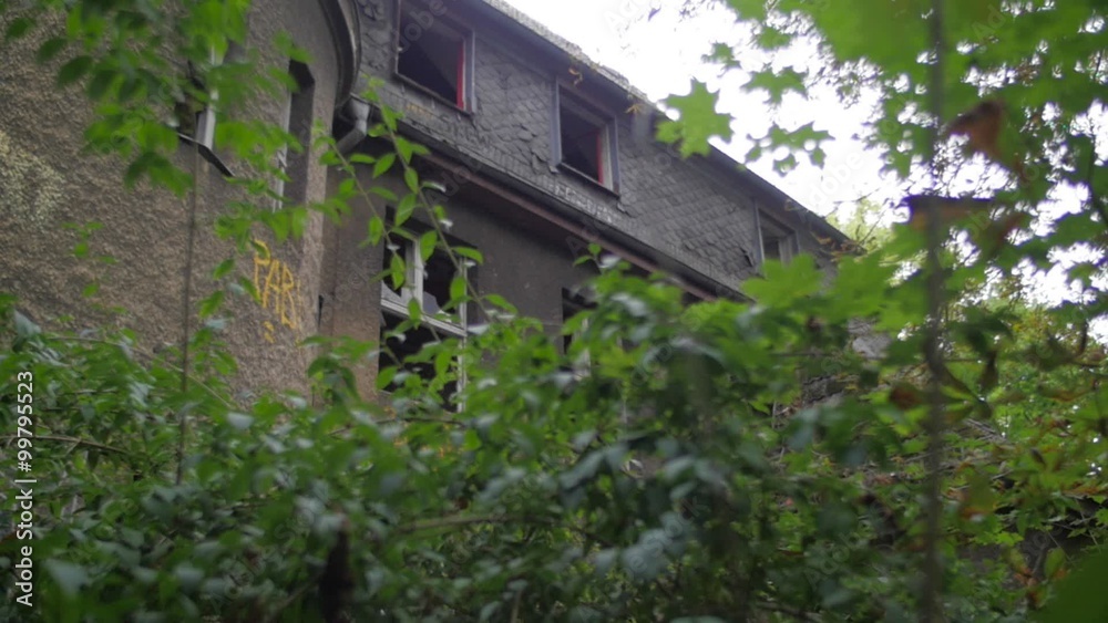 Yard of an abandoned building with broken windows Yard of an abandoned building with broken windows
