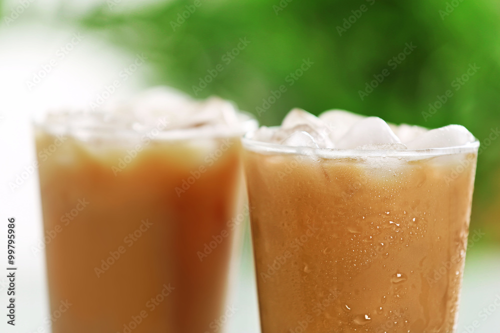 Cups of ice coffee on light blurred background Cups of ice coffee on light blurred background