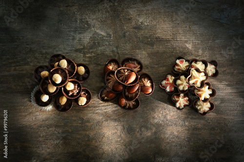 Composition of different chocolate candies on wooden background