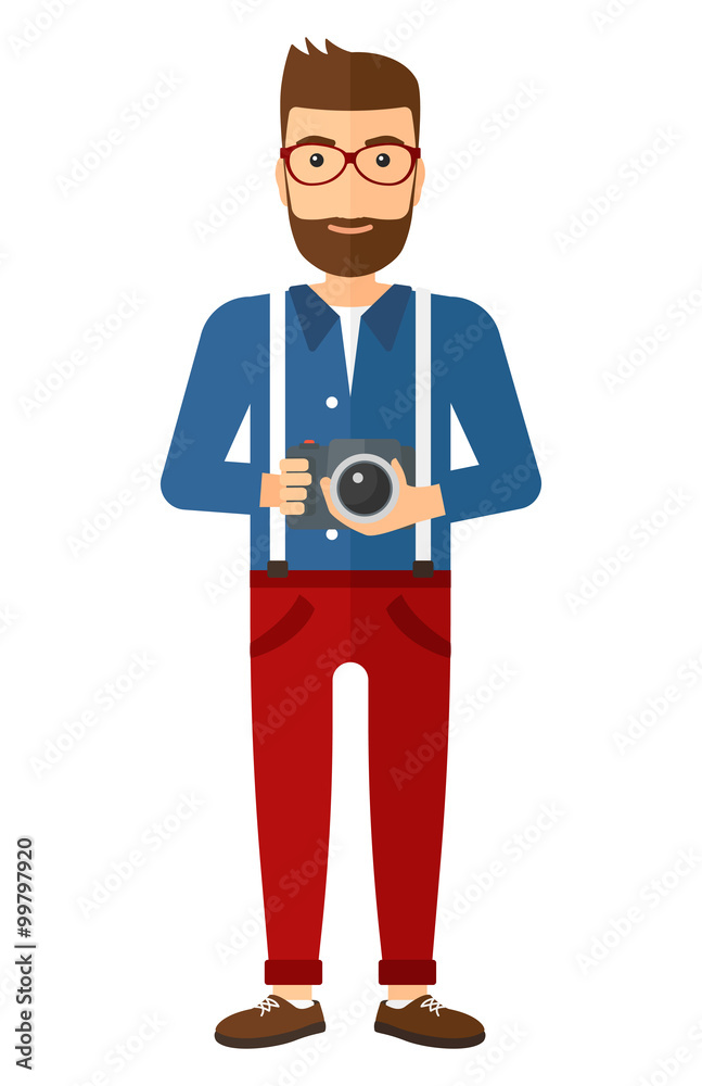 Smiling photographer holding camera.