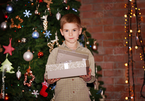 Little boy with gift boxes ...